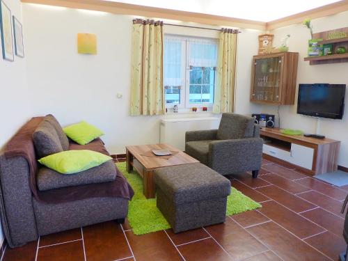 a living room with a couch and two chairs and a tv at Holiday Home Edelmann by Interhome in Schnett