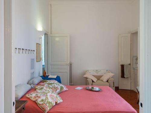a bedroom with a red bed with a plate on it at Apartment Costanza - PRE130 by Interhome in Praelo