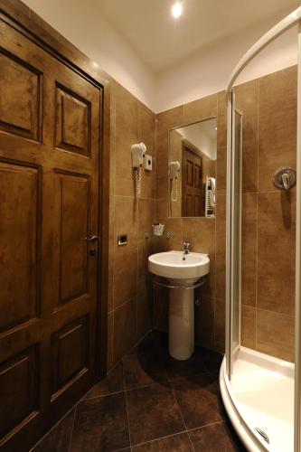 a bathroom with a toilet and a sink and a shower at Hotel City Legnano in Legnano