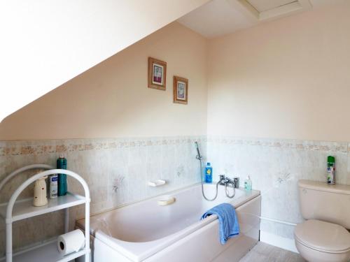 a bathroom with a bath tub and a toilet at Meadowside Farm in Coupar Angus
