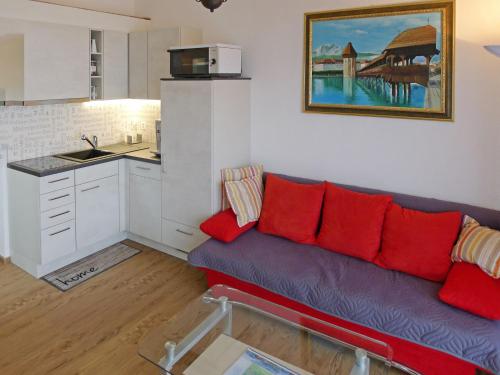 a living room with a purple couch and red pillows at Apartment Ladasa by Interhome in Emmetten