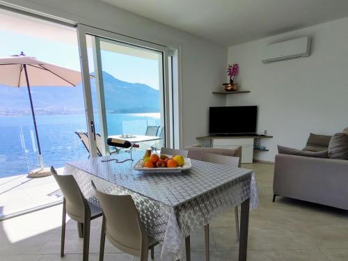 a living room with a table with a bowl of fruit on it at Holiday Home Gelsomino - GLA125 by Interhome in Gera Lario