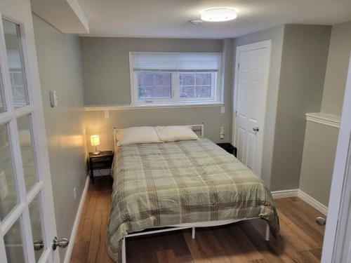 a bedroom with a bed and two windows at Stylish one bedroom Apartment. 