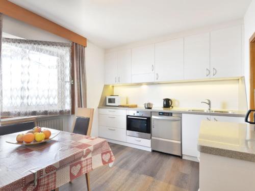 a kitchen with a table with a bowl of fruit on it at Holiday Home Kostner by Interhome in Bulla