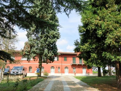 un edificio arancione con alberi di fronte di Holiday Home La Mondianese - AST310 by Interhome a Montemagno