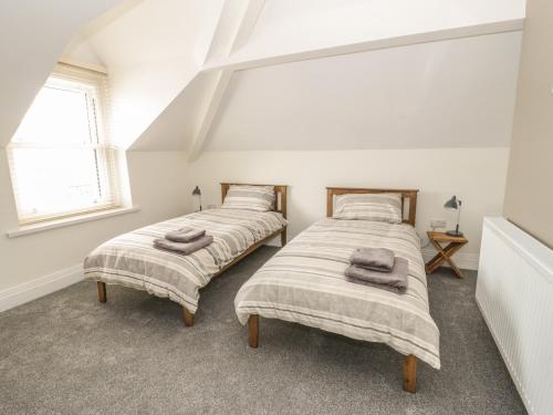 A bed or beds in a room at Charnwood Villa