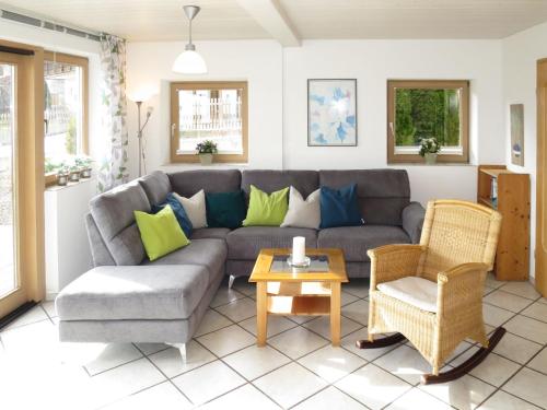 a living room with a couch and a table at Holiday Home Fischer by Interhome in Lechbruck