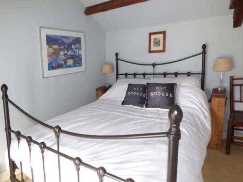 a bedroom with a bed with two pillows on it at The Old Stable in Abergavenny