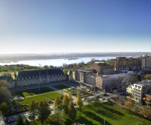 an aerial view of a city with buildings and a park at Hotel Chateau Laurier Québec in Quebec City