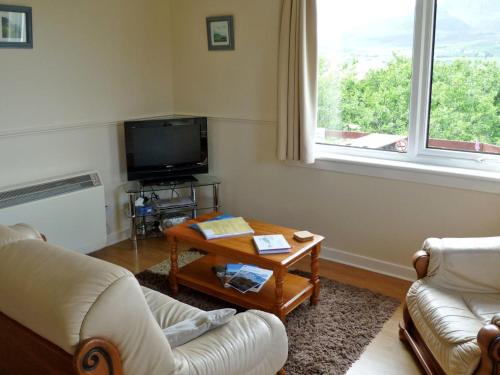 a living room with two couches and a coffee table at Holiday Home Ewan's by Interhome in Staffin