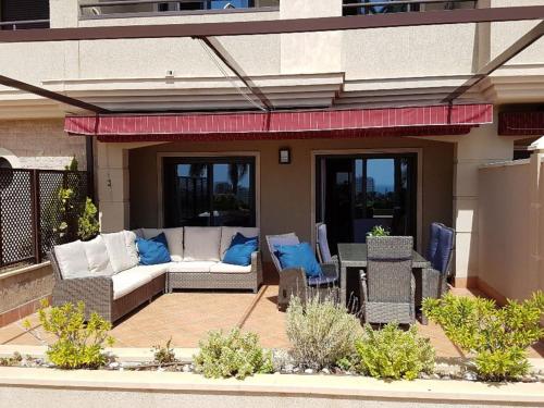 un patio con sofá, mesa y sillas en Apartment Mirador de la Yesera by Interhome, en Santa Fe de los Boliches