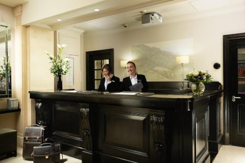 two women sitting at a desk in a room at London Bridge Hotel in London