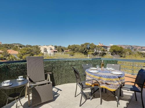 a patio with a table and chairs on a balcony at Apartment Résidence Cap Marine by Interhome in Drammont