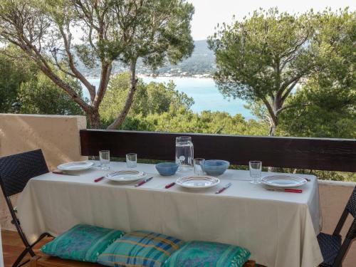 a table with plates and bowls on it with a view at Apartment Mas de la Madrague-8 by Interhome in La Madrague