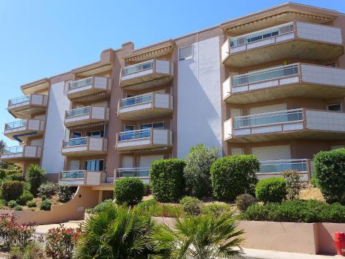 an apartment building with bushes in front of it at Apartment Les Jardins del Mar-2 by Interhome in Cavalaire-sur-Mer