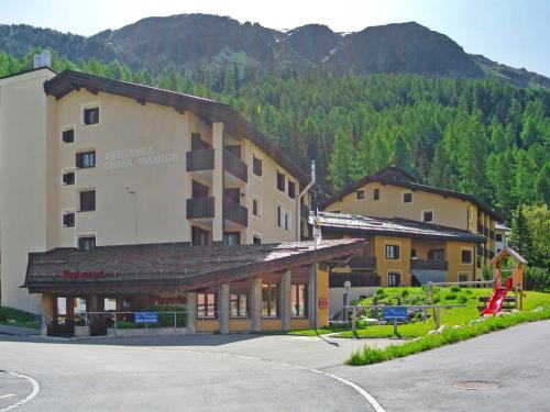 a large building in front of a mountain at Apartment Residenza Chesa Margun 14-7 by Interhome in Surlej