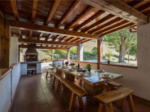Santa Maria a VezzanoにあるHoliday Home Podere Le Ripe by Interhomeの屋外キッチン(大きな木製テーブル、ベンチ付)