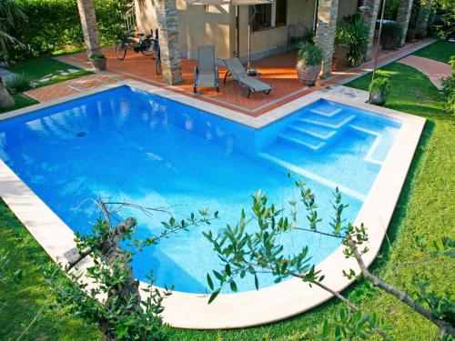 a large blue swimming pool in a yard at Villa Roberto by Interhome in Casa Gherardi
