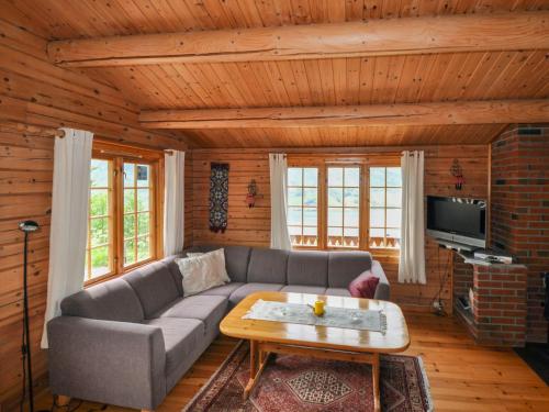 a living room with a couch and a coffee table at Chalet Fjordblick I - FJS311 by Interhome in Olden