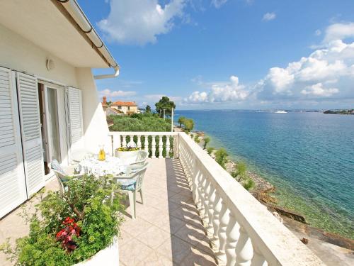 a balcony with a table and chairs and the water at Holiday Home Ana by Interhome in Kali