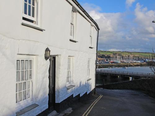 a white building next to a body of water at The Slipway in Penzance