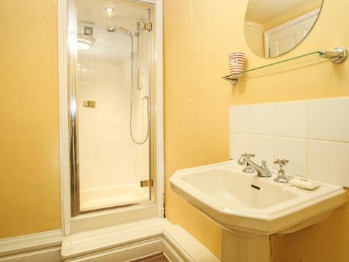 a bathroom with a sink and a shower at The Slipway in Penzance