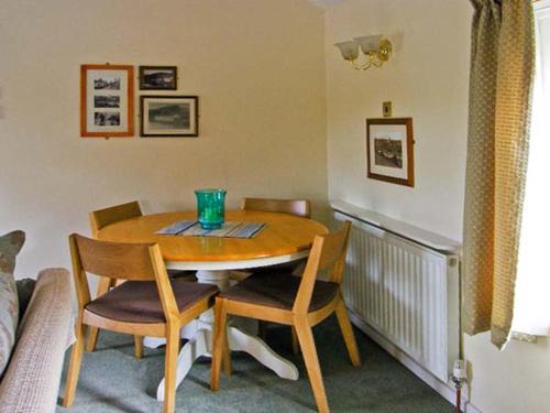 a table and chairs in a room with a table and a couch at Waterloo Cottage Annexe in Ruswarp