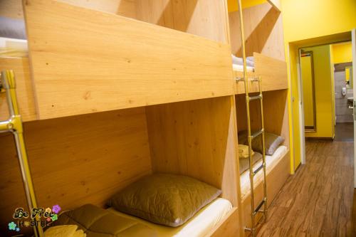 a bunk bed in a room with wooden walls at BeFree Hostel - Self-Service in Vienna