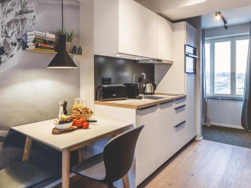 a kitchen with a table and chairs in a room at Apartment Mariandl am Meer-1 by Interhome in Binz