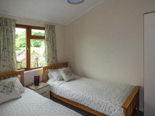 a bedroom with two beds and a window at South Lodge in Staveley