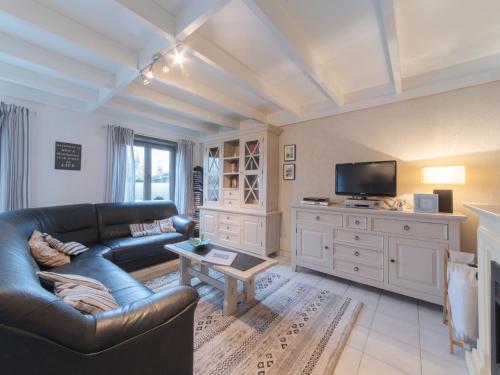 a living room with a couch and a tv at Holiday Home New Village Park-3 by Interhome in Bredene