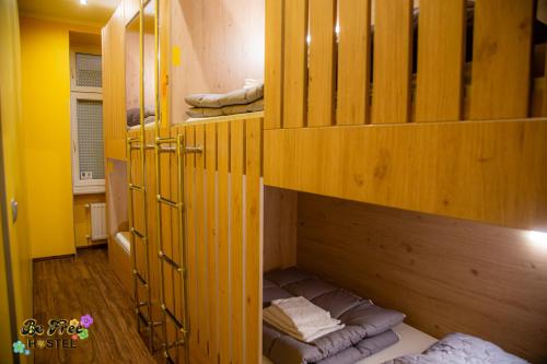 a room with wooden shelves with towels in it at BeFree Hostel - Self-Service in Vienna
