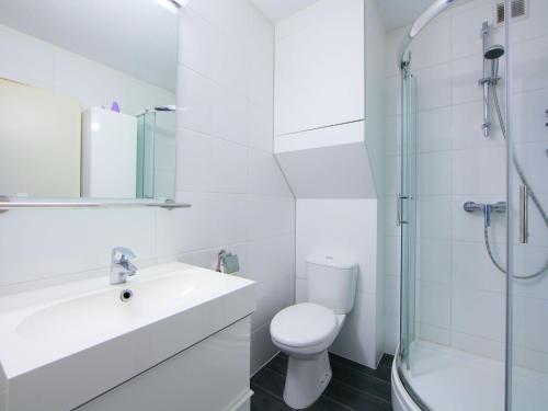 a bathroom with a toilet and a sink and a shower at Studio Studio met garage by Interhome in Bredene