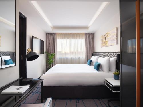 a hotel room with a large bed and a window at Dao by Dorsett West London in London