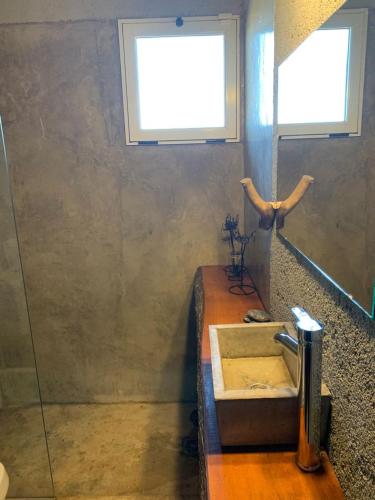 a bathroom with a sink and a window at Yacanto360 in Villa Yacanto