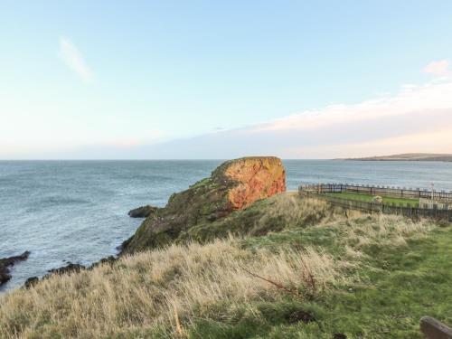 a view of the ocean and a rock formation at The Rest in Eyemouth