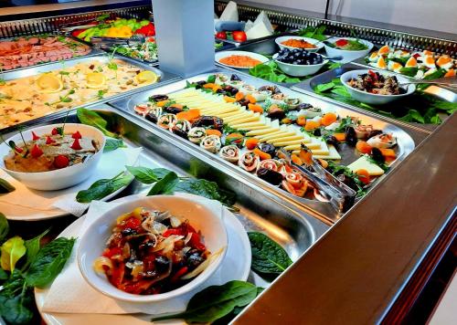 a buffet line with many different types of food at Popasul Domnesc- Resort& Spa- Voronet Vue in Voronet