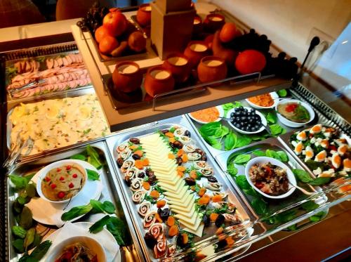 a buffet with many different types of food on display at Popasul Domnesc- Resort& Spa- Voronet Vue in Voronet
