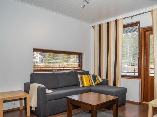 a living room with a couch and a table at Holiday Home Villa ylläs 201 by Interhome in Ylläs