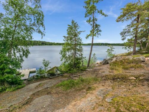 una casa a orillas de un lago con árboles en Holiday Home Elimäki by Interhome, en Heinjoki