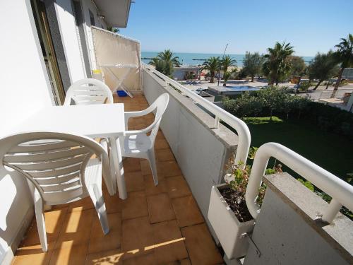 a balcony with a white table and chairs on it at Apartment Cala Luna-2 by Interhome in Porto dʼAscoli