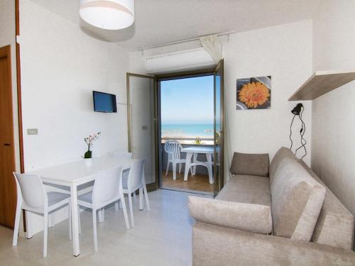 a living room with a couch and a table at Apartment Cala Luna-1 by Interhome in Porto dʼAscoli