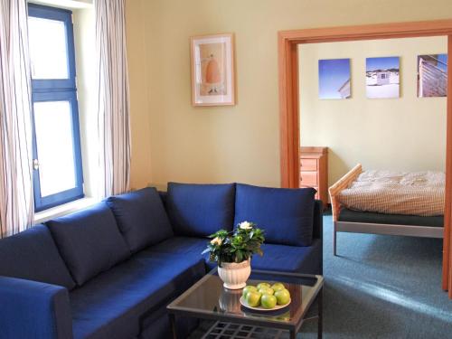 Apartment Twain by Interhome في ماريانسكي لازني: غرفة معيشة مع أريكة زرقاء وطاولة