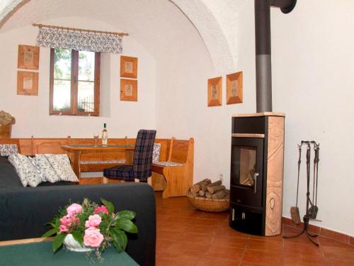 uma sala de estar com um sofá e um fogão a lenha em Holiday Home Chrastov by Interhome em Černov