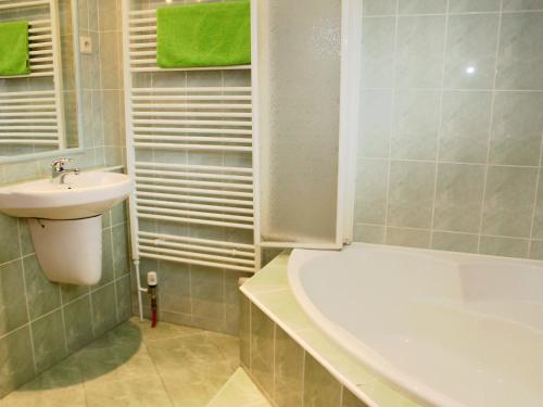 a bathroom with a sink and a bath tub and a sink at Holiday Home Chrastov by Interhome in Černov