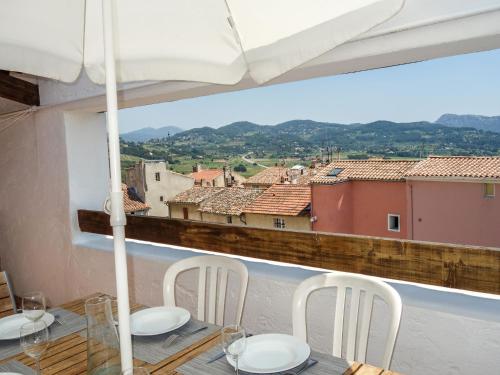 a table with chairs and a view of a city at Holiday Home La Cadièrienne by Interhome in La Cadière-dʼAzur