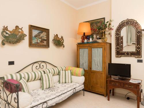 a living room with a couch and a tv at Apartment Positano Elegant Terrace by Interhome in Positano