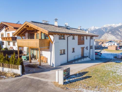 a large white house with a wooden roof at Apartment Lanner by Interhome in Innsbruck