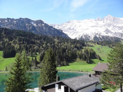 a house with a view of a lake and mountains at Apartment Aurora by Interhome in Engelberg