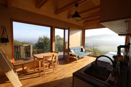 a living room with a table and a couch at Tři domky - tiny houses in Děpoltice
